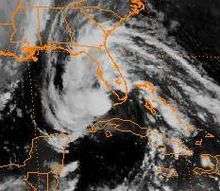 A small storm with a large cloud surrounding about to approach the southwestern side of Florida