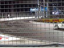 The fifth corner of the Marina Bay Street Circuit viewed behind a metal fence