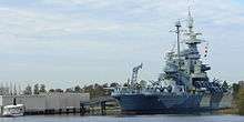 The USS North Carolina Battleship Memorial, seen from downtown Wilmington, across the mouth of the Cape Fear River