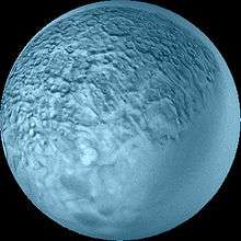 A spherical blueish body with its surface covered by craters and polygons. The lower right part is smooth.