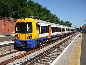 A London Overground train waiting at a platform in the station.