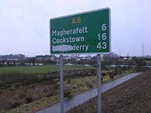 Northern Ireland A6 route sign showing "Londonderry" defaced to read "Derry"