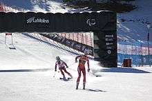 Two female skiers in competition uniform