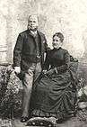 A man and woman, formally dressed, posing for a photograph