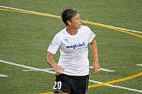 Wambach in a football pitch wearing the MagicJack uniform.