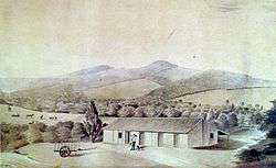 Watercolor depicting a man, dog and cart in front of a farm building, while in the background rise a series of hills on the slopes of which are forest, cattle and fields