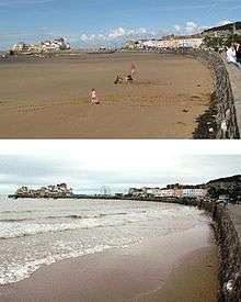Two photographs showing the sea wall and buildings. The left had side is an expanse of sand in the top picture and water covered in the bottom picture.
