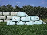 A stack of plastic-wrapped silage bales