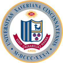 The Xavier University seal, like the St. Xavier seal, bears the schools' coat of arms, which consists of five vertical stripes, an arm holding a crucifix, and three seashells.