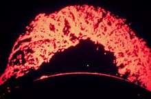 image of a large arching solar prominence