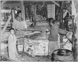 Seminoles stirring a boiling cauldron.